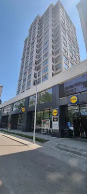 a large white building with a store in front of it at Verano Deluxe Studios in Burgas City