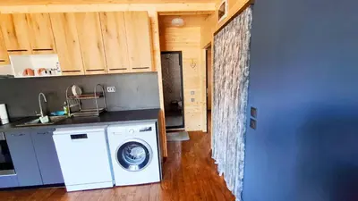 a kitchen with a washing machine in a kitchen at Еко Къщи Градина in Sozopol