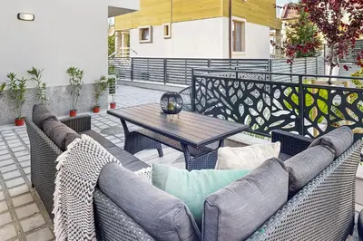 a patio with a couch and a table on a balcony at BellaViaStay, Flat Thalassa 1BD in Sozopol
