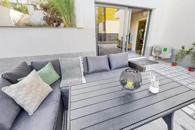 a couch and a table on a patio at BellaViaStay, Flat Thalassa 1BD in Sozopol