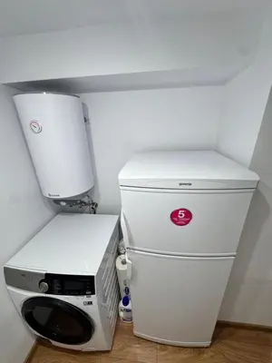 a small kitchen with a refrigerator and a printer at Studio Briz in Burgas City