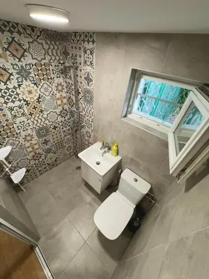 a bathroom with a white toilet and a sink at Studio Briz in Burgas City