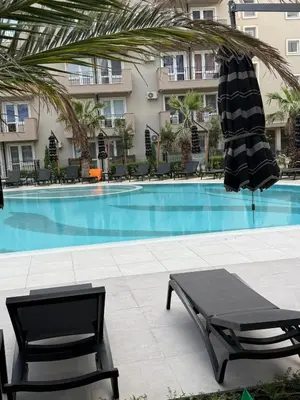 a swimming pool with a table and a umbrella at Sea Home 9 in Sunny Beach
