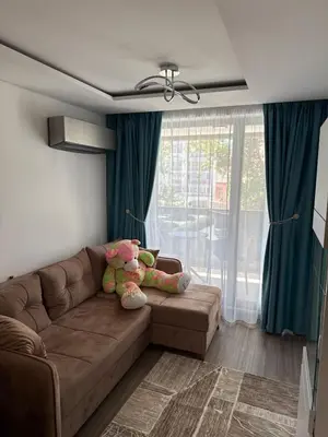 a living room with a brown couch with a stuffed animal at Sea Home 9 in Sunny Beach