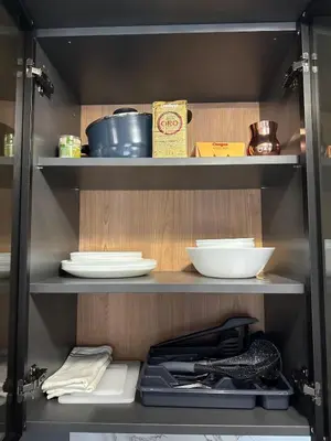 a shelf with plates and bowls in a kitchen at Sea Home 9 in Sunny Beach