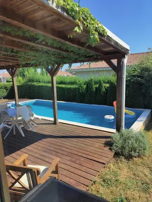 a wooden deck with a pergola and a swimming pool at Villa Casablanca with private pool in Lozenets