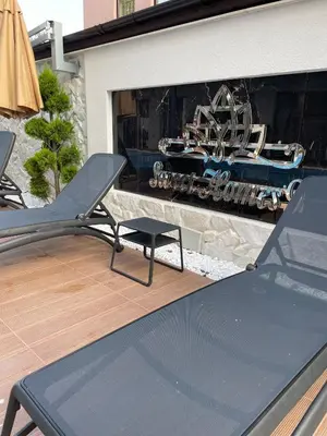 a patio with a table and a train in a window at Sunny Bay Sweet Homes Lux Apartment in Sunny Beach