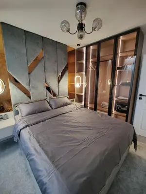 a bedroom with a large bed and a chandelier at Sunny Bay Sweet Homes Lux Apartment in Sunny Beach