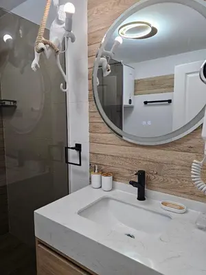 a bathroom with a sink and a mirror at Sunny Bay Sweet Homes Lux Apartment in Sunny Beach