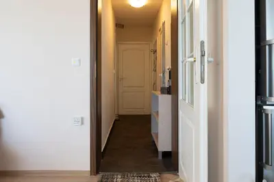 a hallway with a white door and a hallwayngth at Galata Relax in Varna City