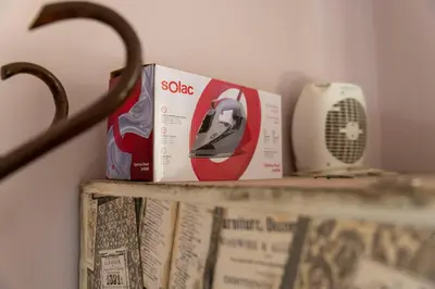 a book and a fan sitting on a shelf at Galata Relax in Varna City