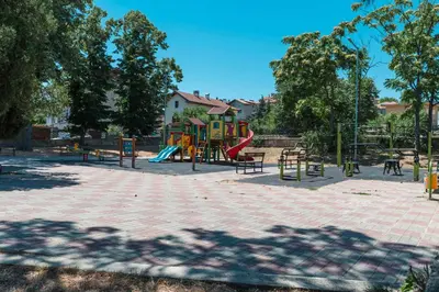 a park with a playground with slides and benches at Galata Relax in Varna City