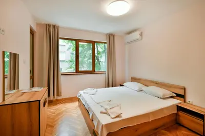 a bedroom with a bed and a large window at Central location 2BR - 6 guests in Varna City