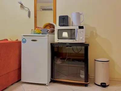 a microwave on a table next to a refrigerator at Prime Location Studio Midia Beach in Sunny Beach