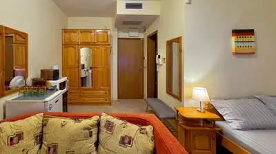 a living room with a couch and a kitchen at Prime Location Studio Midia Beach in Sunny Beach