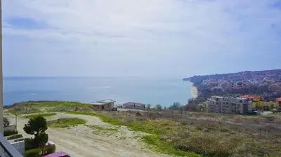 a dirt road next to the ocean on a hill at Fortuna Cape B46 - Фортуна Кейп В46 in Byala