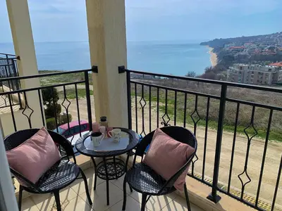 a balcony with a table and chairs and the ocean at Fortuna Cape B46 - Фортуна Кейп В46 in Byala