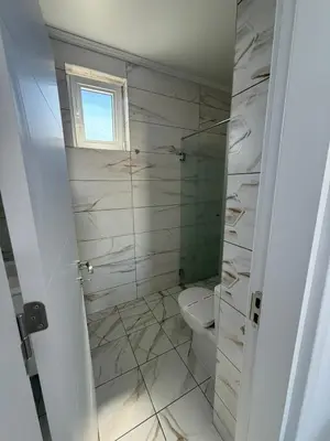 a bathroom with a toilet and a glass shower at Aurum Villas Smokinya Beach 3 in Sozopol
