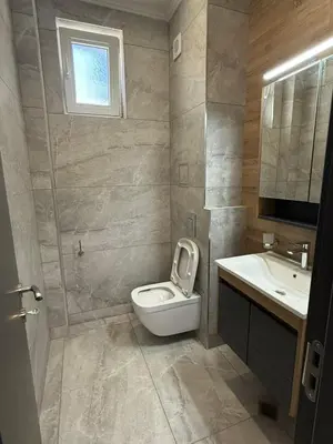 a bathroom with a toilet and a sink at Aurum Villas Smokinya Beach 3 in Sozopol