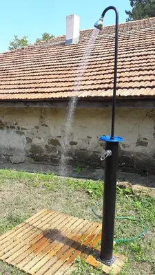 a water fountain in front of a house at Bulgarian country house near the sea in Banya