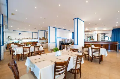a dining room with white tables and chairs at MPM Hotel Condor - All Inclusive Light in Sunny Beach