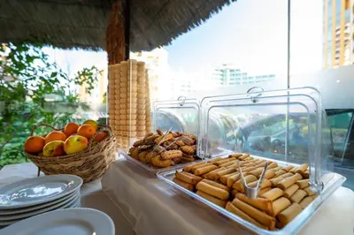 a table with a tray of food and a basket of fruit at MPM Hotel Condor - All Inclusive Light in Sunny Beach