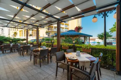 an outdoor dining area with tables and chairs at MPM Hotel Condor - All Inclusive Light in Sunny Beach