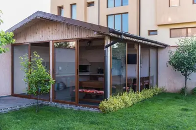 a glass house with a pitched roof at Guest House Georgievi in Primorsko