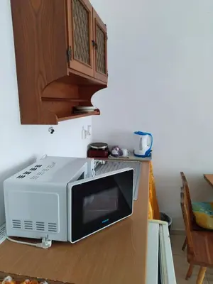 a microwave sitting on top of a kitchen counter at Партерни студия без обособен балкон ул Т Светослав 5 и ул България in Pomorie