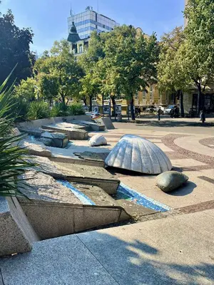 a park with a sculpture of an turtle on the ground at Centrino in Burgas City