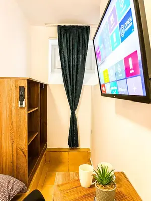 a living room with a tv and a table at Centrino in Burgas City