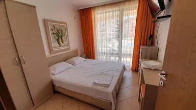 a small bedroom with a bed and a window at 2 Room Apartment Royal Sun E24 with Poolview and big Balcony in Sunny Beach
