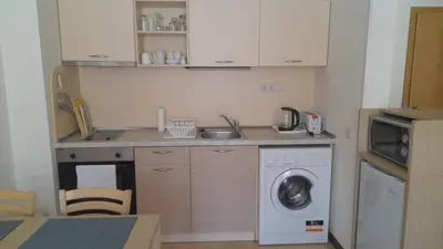 a kitchen with a sink and a washing machine at 2 Room Apartment Royal Sun E24 with Poolview and big Balcony in Sunny Beach