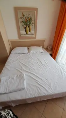 a white bed in a bedroom with a painting on the wall at 2 Room Apartment Royal Sun E24 with Poolview and big Balcony in Sunny Beach