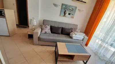 a living room with a couch and a table at 2 Room Apartment Royal Sun E24 with Poolview and big Balcony in Sunny Beach