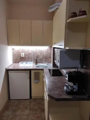 a small kitchen with a sink and a microwave at Blue Beach Apartments - Melia in Ravda