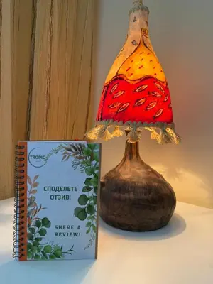 a lamp sitting on a table next to a book at TROPIC BEACH apart in Sunny Beach