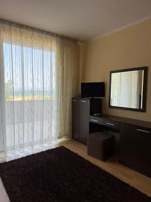 a living room with a television and a large window at TROPIC BEACH apart in Sunny Beach