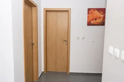 a hallway with a wooden door in a room at Paradise View Guest Apartment in Sozopol