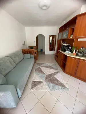 a living room with a couch and a kitchen at Family Paradise in Laguna Beach Hotel in Sozopol