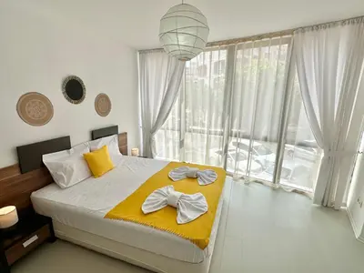 a bedroom with a large bed with two towels on it at Rainbow 3 - Menada Apartments in Sunny Beach