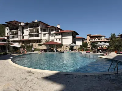 a large swimming pool in front of a building at Stylish studio near harbor and luxury beach in Sveti Vlas