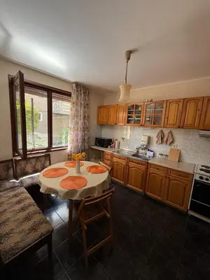 a kitchen with a table in the middle of it at Pomorie S&T Home in Pomorie