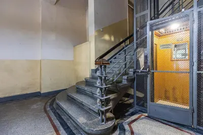 a spiral staircase in a building with a yellow door at California in Varna City