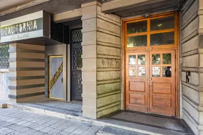 a building with a wooden door on a street at California in Varna City