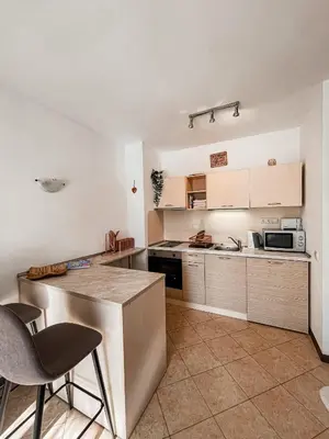 a kitchen with a counter and some chairs in it at Royal Sun - Vaio - 1BR Apt with Balcony - Pool View in Sunny Beach