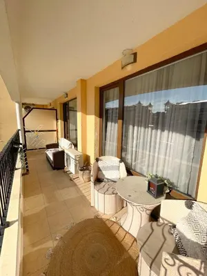 a balcony with a table and chairs on a building at Royal Sun - Vaio - 1BR Apt with Balcony - Pool View in Sunny Beach