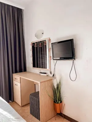 a bedroom with a desk and a tv on a wall at Royal Sun - Vaio - 1BR Apt with Balcony - Pool View in Sunny Beach