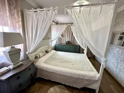 a bedroom with a canopy bed and a dresser at Luxury 3-BR apartment & sky terrace in Sveti Vlas