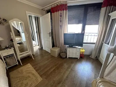 a living room with a television on a wooden floor at Luxury 3-BR apartment & sky terrace in Sveti Vlas